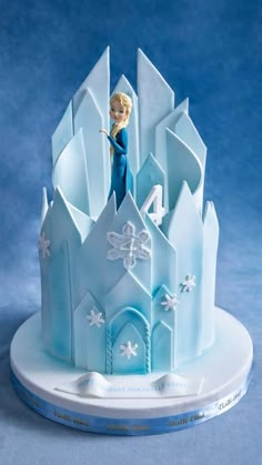 a frozen princess castle cake on a plate