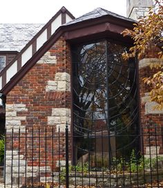 an old brick building with a large iron window