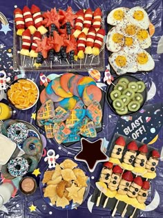 a table topped with lots of food and desserts