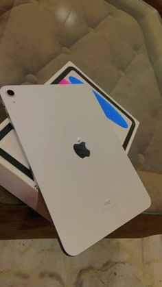 two apple ipads sitting on top of each other