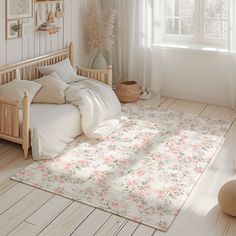 a bedroom with white walls and flooring has a floral rug on the wooden floor