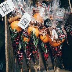 some oranges and other fruit are on display in a crate with plastic wrap around them