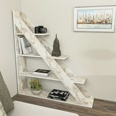 a white book shelf with books and cameras on it