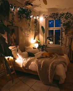 a bedroom with plants on the wall and lights in the ceiling, along with a bed