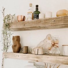 two wooden shelves filled with dishes and cups