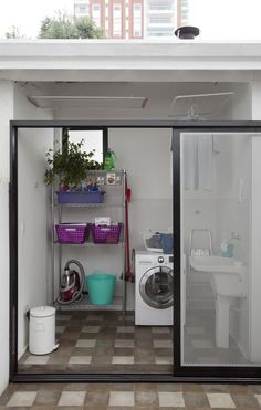 an open door to a washer and dryer in a room with tiled floors