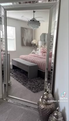 a bedroom with a large mirror on the wall