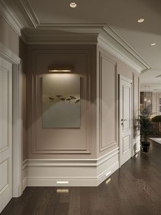 an empty room with wood floors and white walls, painted in neutral colors on the wall