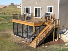 a house with a deck and patio in the yard