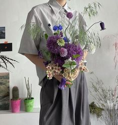 a man holding a bouquet of flowers in his hands