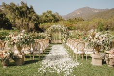 an outdoor ceremony set up with chairs and flowers