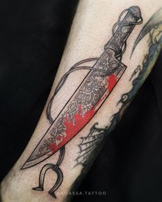 a tattoo on the arm of a person holding a knife