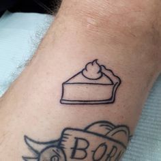 a tattoo on the arm of a man with a piece of cake