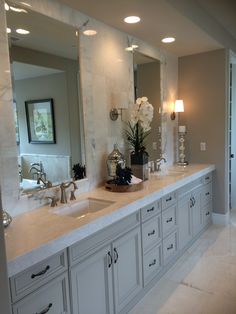 a large bathroom with double sinks and mirrors