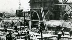 an old black and white photo of men working at a construction site in the early 1900's