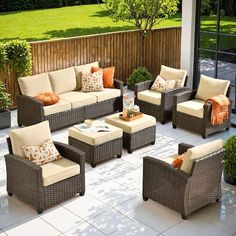 an outdoor living area with furniture and plants