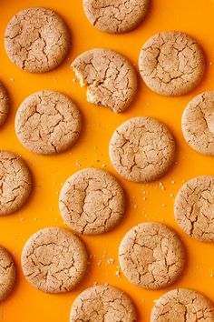 cookies are arranged in rows on an orange surface