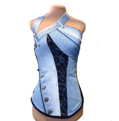 a female mannequin wearing a denim top with an asymmetrical design