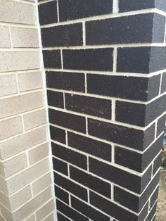 a black and white brick wall next to a building