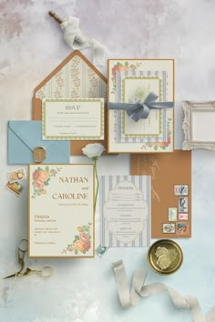 the wedding stationery is laid out on top of each other with ribbons and paper