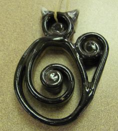 a black cat brooch sitting on top of a table