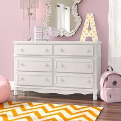 This 6-drawer double dresser offers extra storage space in your little one's bedroom or play space. The frame is crafted from solid wood with a crisp white finish, and it rests on carved, spindle legs for a traditional look. Six dovetailed drawers open on ball-bearing glides, revealing room for reading glasses, books, and other bedside essentials. We love how the shiplap paneling, crown molding, and curtained apron on the bottom give this piece plenty of vintage-inspired charm. Plus, this dresse Shiplap Paneling, Dresser Brown, 8 Drawer Dresser, 7 Drawer Dresser, 4 Drawer Dresser, Box Spring Bed, 9 Drawer Dresser, Kids Dressers, Blue Chair