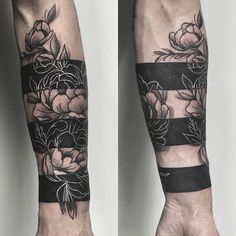 two hands with black and white flowers on them