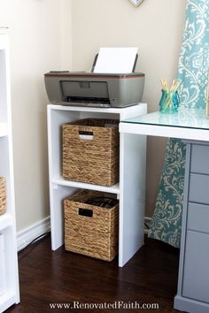 a desk with two baskets and a printer on it