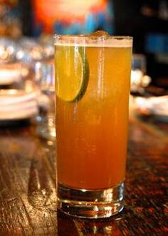 a tall glass filled with liquid sitting on top of a table