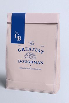 the bag is white with blue trim and has a logo on it that reads, the greatest doughman bread and baked goods