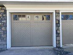 two garage doors with windows on each side