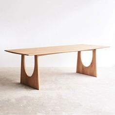 a wooden table sitting on top of a white floor