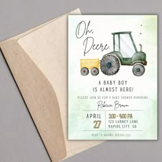 a green tractor baby shower is shown on the front of a card with an envelope