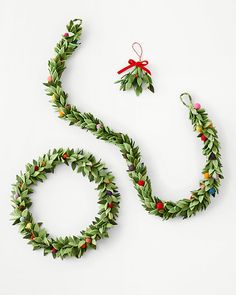 a christmas wreath and other decorations on a white surface