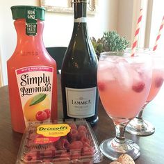 some drinks are sitting on a table next to bottles