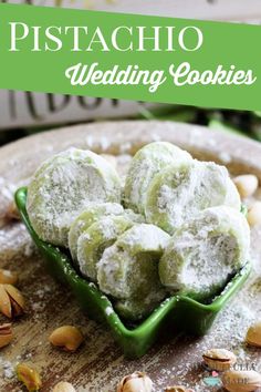 pistachio wedding cookies in a green bowl with almonds on the side and text overlay that reads, pistachio wedding cookies