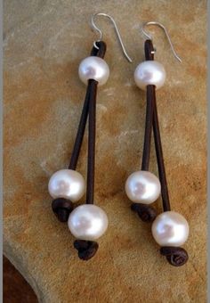 two pairs of earrings with white pearls on them