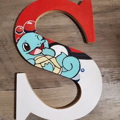 the letter g is made up of wood and has an image of a cartoon character on it