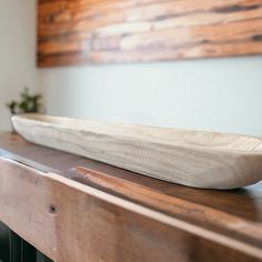 a wooden bowl sitting on top of a table