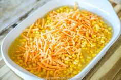 a white dish filled with corn and carrots