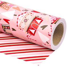 a roll of pink wrapping paper sitting on top of red and white stripes