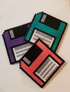 three coasters made out of different colored materials on a white surface with black dots