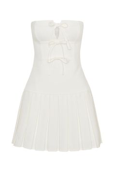 Playfully pleated. Elevate your style with the NAYA Pleated Mini Dress With Ties, a perfect blend of sophistication and charm. This strapless dress features a fitted bodice that accentuates your curves, while the pleated lower skirt creates a flirty and flowing silhouette. The centre back invisible zip offers a seamless fit, ensuring comfort and ease of wear. A delightful front tie detail adds a playful touch, making this dress ideal for both formal occasions and festive gatherings. Ceremony Dresses, Pleated Mini Dress, Black Tie Wedding, Invisible Zip, Dress With Tie, Bridal Shop, Fitted Bodice, Black Tie, Formal Occasion