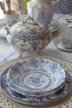 blue and white dishes are on a table