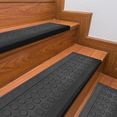 three black mats on the steps leading up to a door