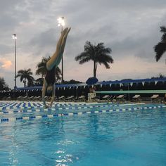 a person jumping into a swimming pool