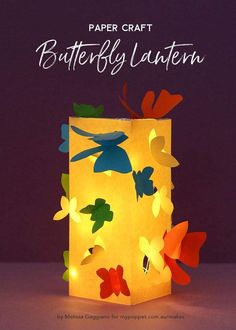 a paper lantern with colorful butterflies on it and the words butterfly lantern written in white