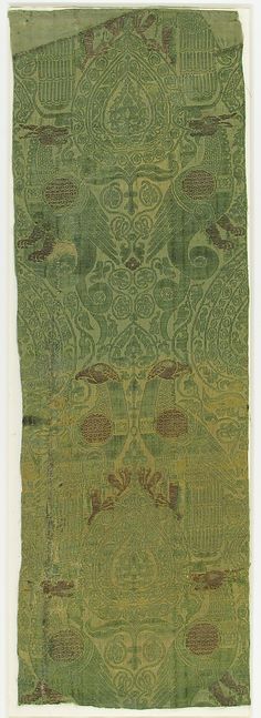 an old green rug with designs on it