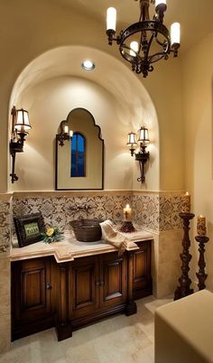 a bathroom with a chandelier, sink and mirror