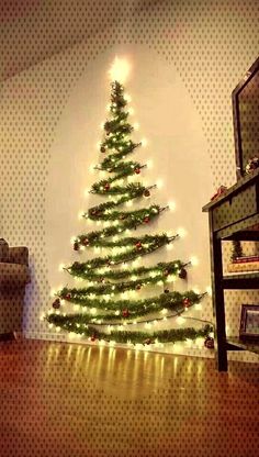 a living room with a christmas tree on the wall